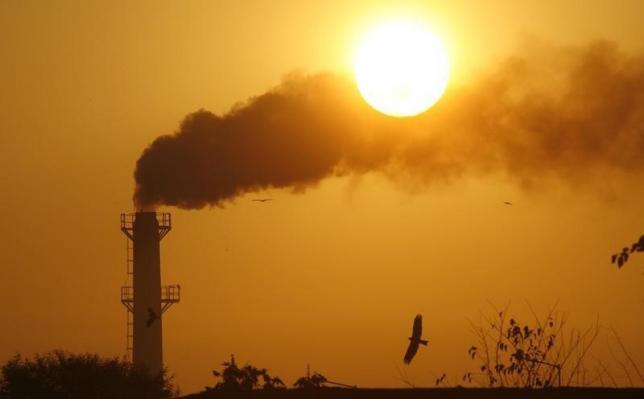 Smoke rises from a chimney of a garbage processing plant on the outskirts of Chandigarh December 3, 2011. Reuters/Ajay Verma/Files